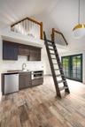 Kitchen featuring dishwasher, high vaulted ceiling, light wood finished floors, a sink, and stainless steel oven