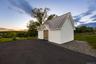 Outdoor structure at dusk with french doors