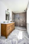 Bathroom with vanity and tiled shower