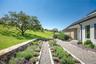 View of green lawn with a garden