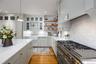 Kitchen with a sink, open shelves, decorative light fixtures, decorative backsplash, and recessed lighting
