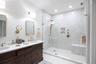 Full bathroom featuring double vanity and walk in shower