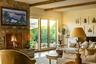 Living area featuring wood finished floors and beam ceiling