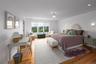 Bedroom with Walk-in closets along with light wood-style flooring and recessed lighting