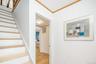 Stairway featuring crown molding and wood finished floors