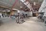 Gym featuring high vaulted ceiling, metal wall, and a workshop area