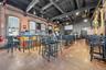 Dining area with brick wall, a towering ceiling, and finished concrete flooring