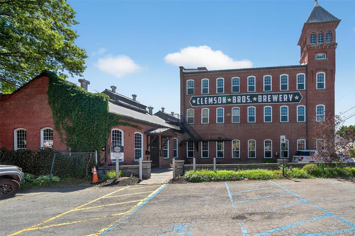 View of building exterior with uncovered parking