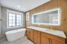 Primary spa bath with soaking tub and standing shower