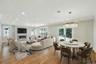Open layout dining and living room with fireplace.  Virtual staging