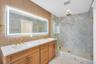 Primary spa bath with soaking tub and standing shower