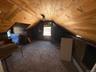 Bonus room with wooden ceiling, light carpet, wood walls, and vaulted ceiling