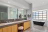 Soaking Tub – Freestanding tub set beneath large windows for a resort feel.