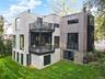 Rear Exterior – Clean-lined design with expansive glass and private, landscaped surroundings.