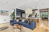Bright, airy living spaces framed by black steel casement windows and natural light.