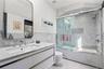 En-Suite Bath – Sleek bath with glass-enclosed shower and contemporary vanity.