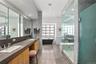 Primary Bath – Spa-style bath with double vanity and oversized steam shower and supersized walk-in closet