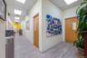 Hallway with a paneled ceiling and wood finished floors