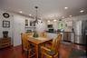 Dining area with recessed lighting and dark wood finished floors