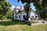 Back of property featuring a lawn, a patio, and a chimney