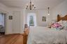 Bedroom featuring radiator, a chandelier, and wood finished floors