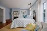 Bedroom with a fireplace and wood finished floors
