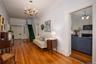 Sitting room featuring a chandelier, crown molding, wood-type flooring, a fireplace, and stairs