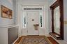 Foyer entrance with radiator heating unit and wood finished floors