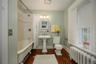 Bathroom featuring radiator, dark wood-style flooring, and shower / bath combo with shower curtain