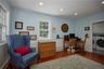 Office space with wood finished floors, recessed lighting, washing machine and clothes dryer, and wainscoting