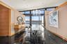 Dining area with expansive windows, plenty of natural light, and a water view