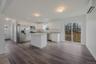 Kitchen with stone countertops, white soft close cabinets plus stainless appliances