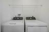 Laundry room with washer and dryer located on the first floor with half bath