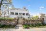 View of front of property featuring a fenced front yard, stairway, and stucco siding