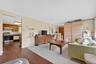 Living room featuring dark wood-type flooring and baseboards