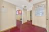 Hallway with baseboards and carpet