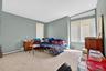 Bedroom featuring carpet flooring and a baseboard heating unit
