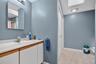 Bathroom with vanity, light tile patterned floors, and a skylight