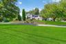 View of grassy yard featuring stairs