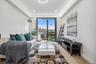 Living area featuring light wood-style flooring, baseboards, recessed lighting, and a raised ceiling