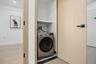 Washroom featuring washer / clothes dryer and light wood-style flooring