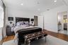 Bedroom with wood finished floors, crown molding, recessed lighting, and connected bathroom