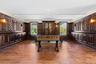 Playroom with ornamental molding, plenty of natural light, and dark wood finished floors