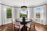 Dining area featuring a chandelier, dark wood finished floors, and crown molding