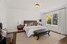Bedroom with dark wood-style floors and crown molding