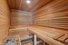 Sauna / steam room featuring wooden walls and wooden ceiling