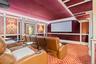 Cinema with a decorative wall, carpet, and ornamental molding