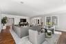 Living room with ornamental molding, dark wood-type flooring, and recessed lighting