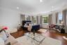 Bedroom with ornamental molding, wood finished floors, multiple windows, and recessed lighting