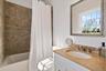 Bathroom with shower / tub combo and vanity